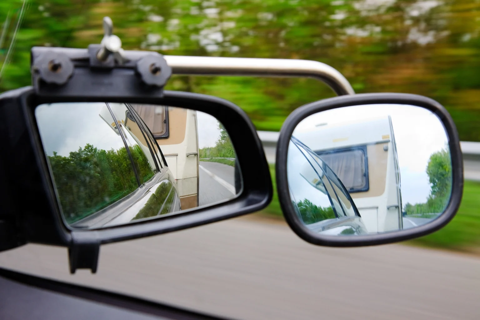 Extended Mirror Attached To Car Towing A Caravan